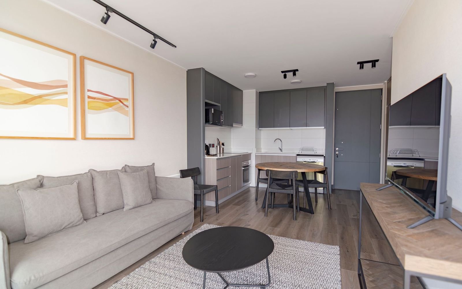 Bright family living room with a grey sofa and an open kitchen