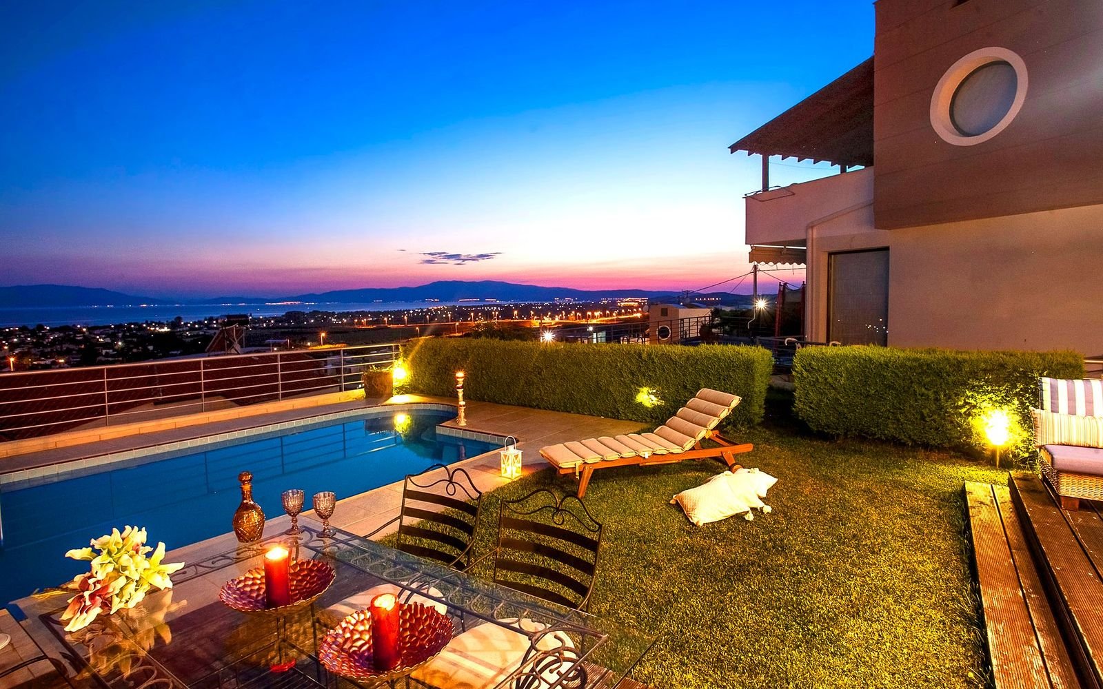 Garden terrace and swimming pool at sunset, with outdoor lighting and pool area upkeep