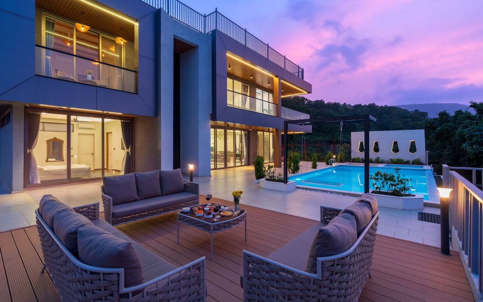 Modern villa terrace and swimming pool at sunset, the kind of home covered by villa maintenance