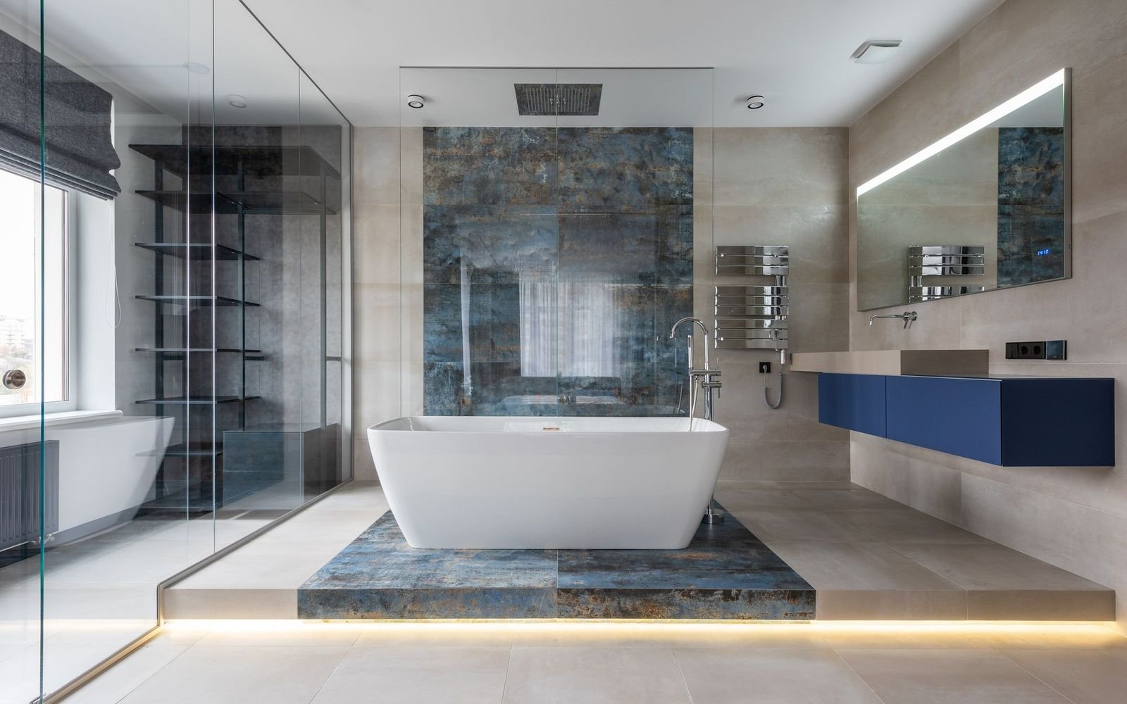 Modern bathroom with a freestanding bath and glass walls, an example of a finished bathroom renovation